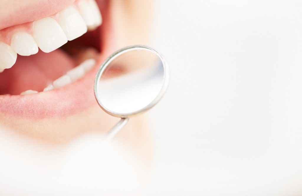 Close-up of open mouth during oral checkup at the dentist’s