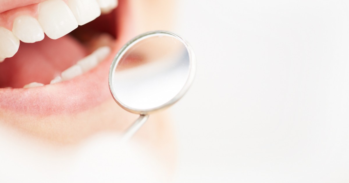 Close-up of open mouth during oral checkup at the dentist’s